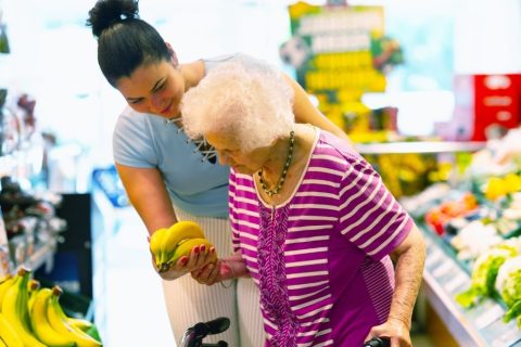 caregiver-helping-elderly-in-grocery-shopping